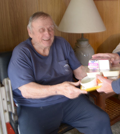 a senior being served food form Meals on Wheels Orange County