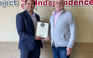 Robbie LaBounty, District Representative, Office of Supervisor Katrina Foley, 5th District, presenting certificate to Bob Watson, CEO of Project Independence