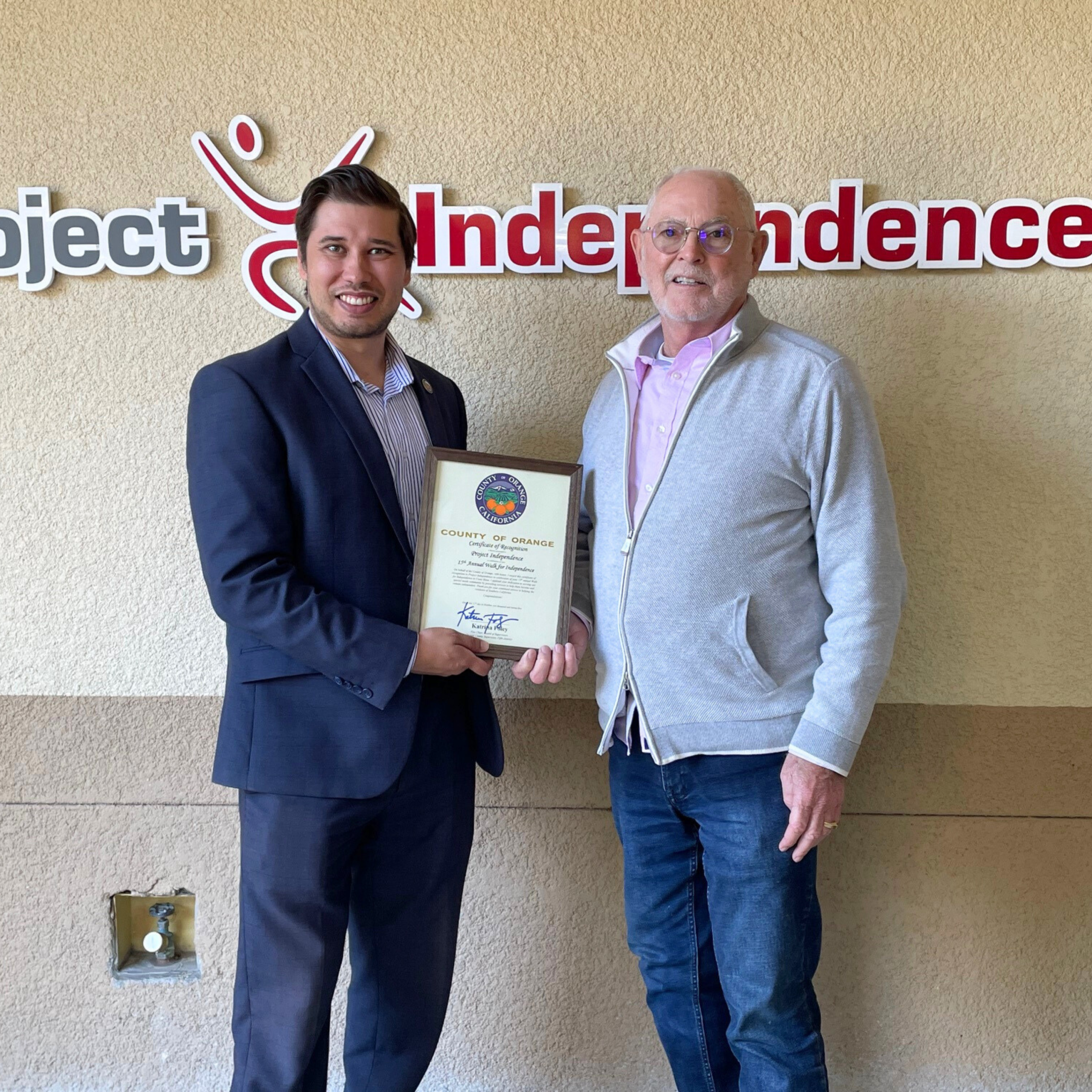 Robbie LaBounty, District Representative, Office of Supervisor Katrina Foley, 5th District, presenting certificate to Bob Watson, CEO of Project Independence